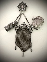 A sterling Chatelaine with a perfume, small coin purse and a match safe