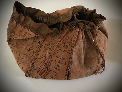 A rare, and  humorous  leather postcard purse