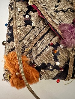 dowry purse, showing corner detail with metallic threads, velvet base, glass bead, and small  metalsequin